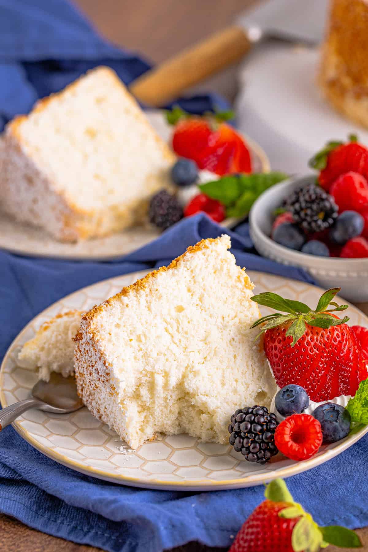 Slice of light and fluffy angel food cake with a forkful removed.