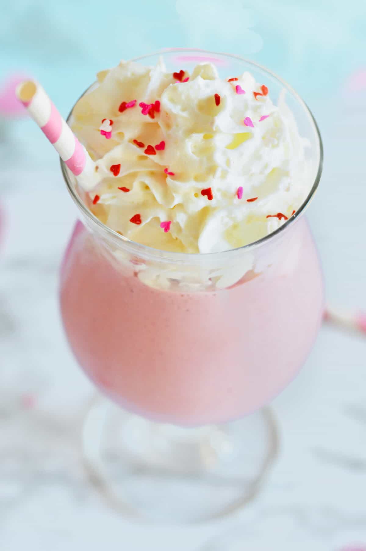 Strawberry mudslide drink topped with whipped cream and heart sprinkles.