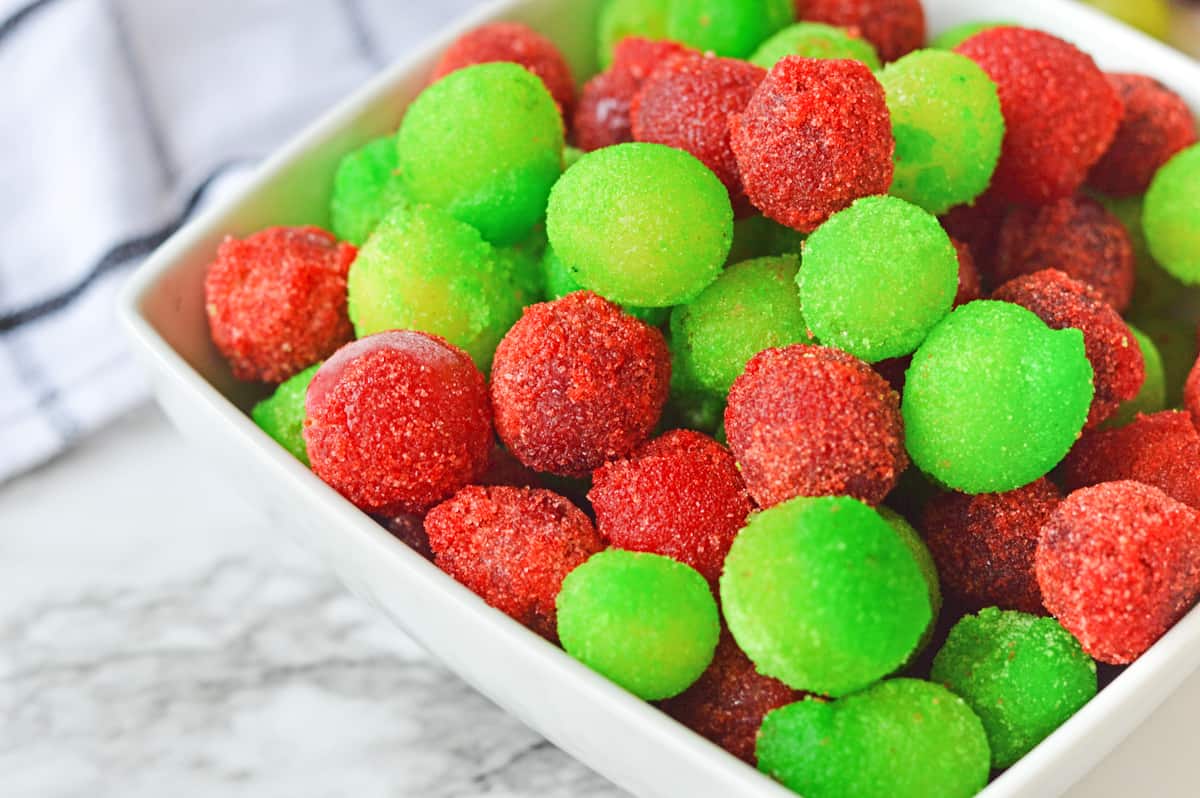 Close up of red and green frozen jello grapes.