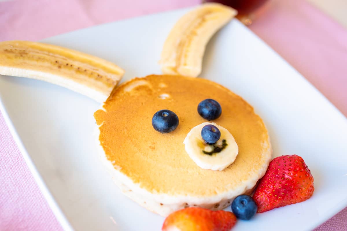 Pancake decorated with fresh fruit to look like a bunny rabbit.