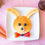 Bunny pancakes decorated with bananas and berries.