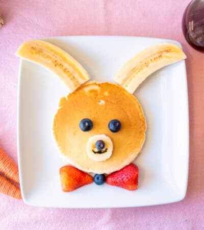 Bunny pancakes decorated with bananas and berries.
