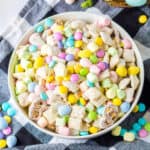 Easter muddy buddies chex mix in a white serving bowl.