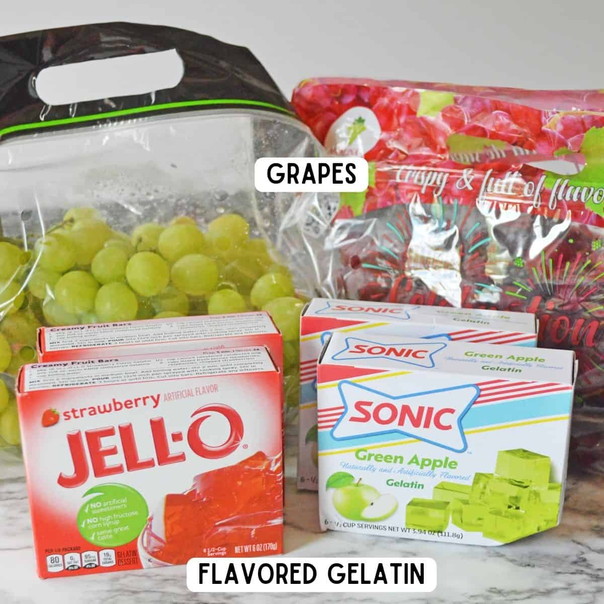 Bag of green grapes, bag of red grapes, strawberry jello mix, and Sonic green apple gelatin.