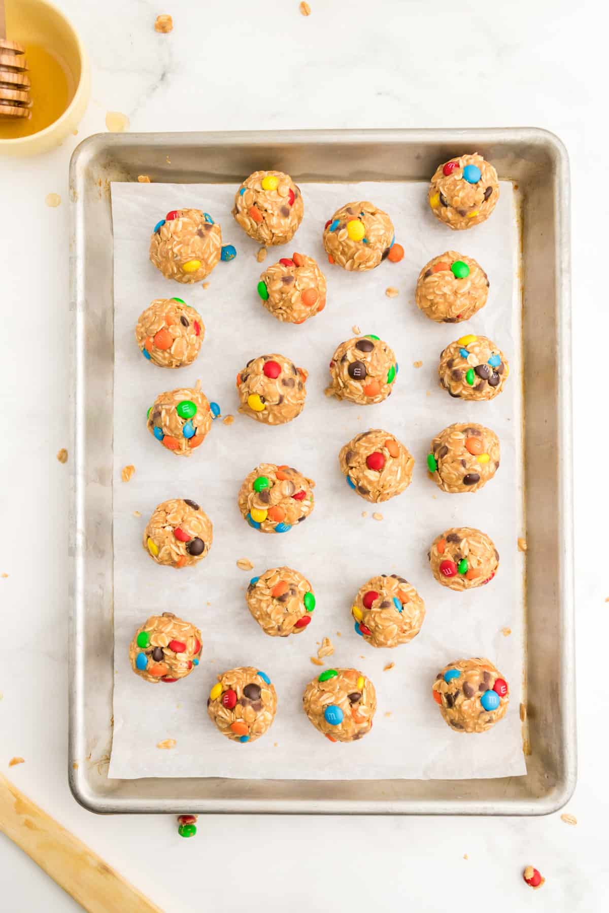 Monster Energy Cookie Balls on lined baking sheet.