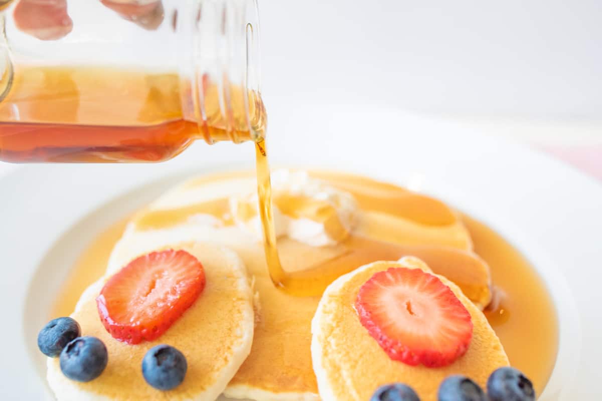 Syrup being poured on Easter bunny pancakes.