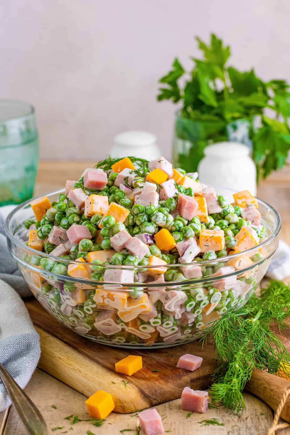 Ham and pea salad with cheese, red onion, and a creamy dressing.