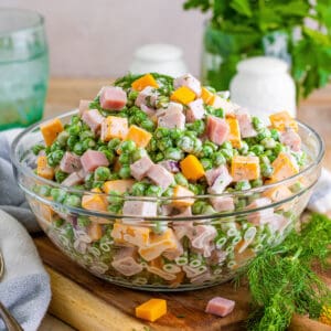 Ham and pea salad with cheese, red onion, and a creamy dressing.