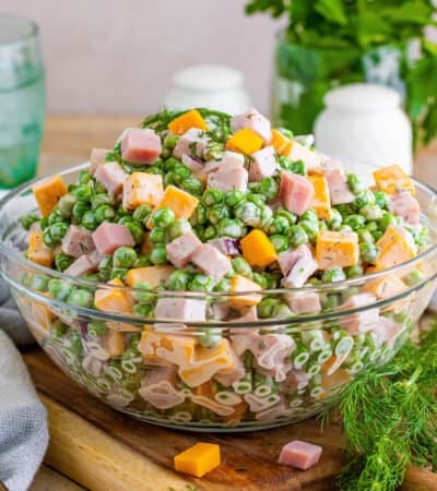 Ham and pea salad with cheese, red onion, and a creamy dressing.