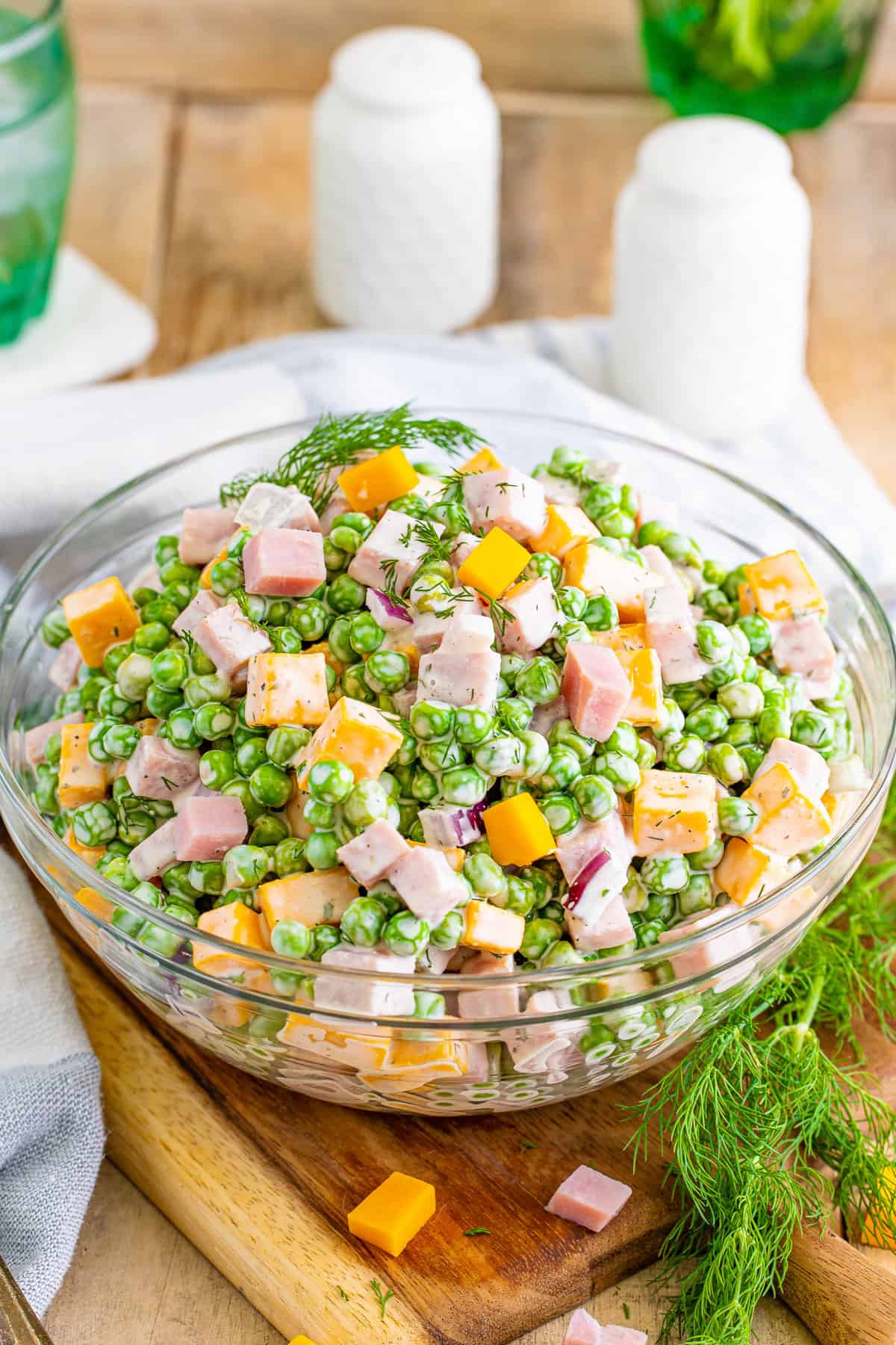 Ham and pea salad with sweet green peas, cubed ham, cubed cheese, red onion, fresh dill, all tosses in a creamy dressing. 