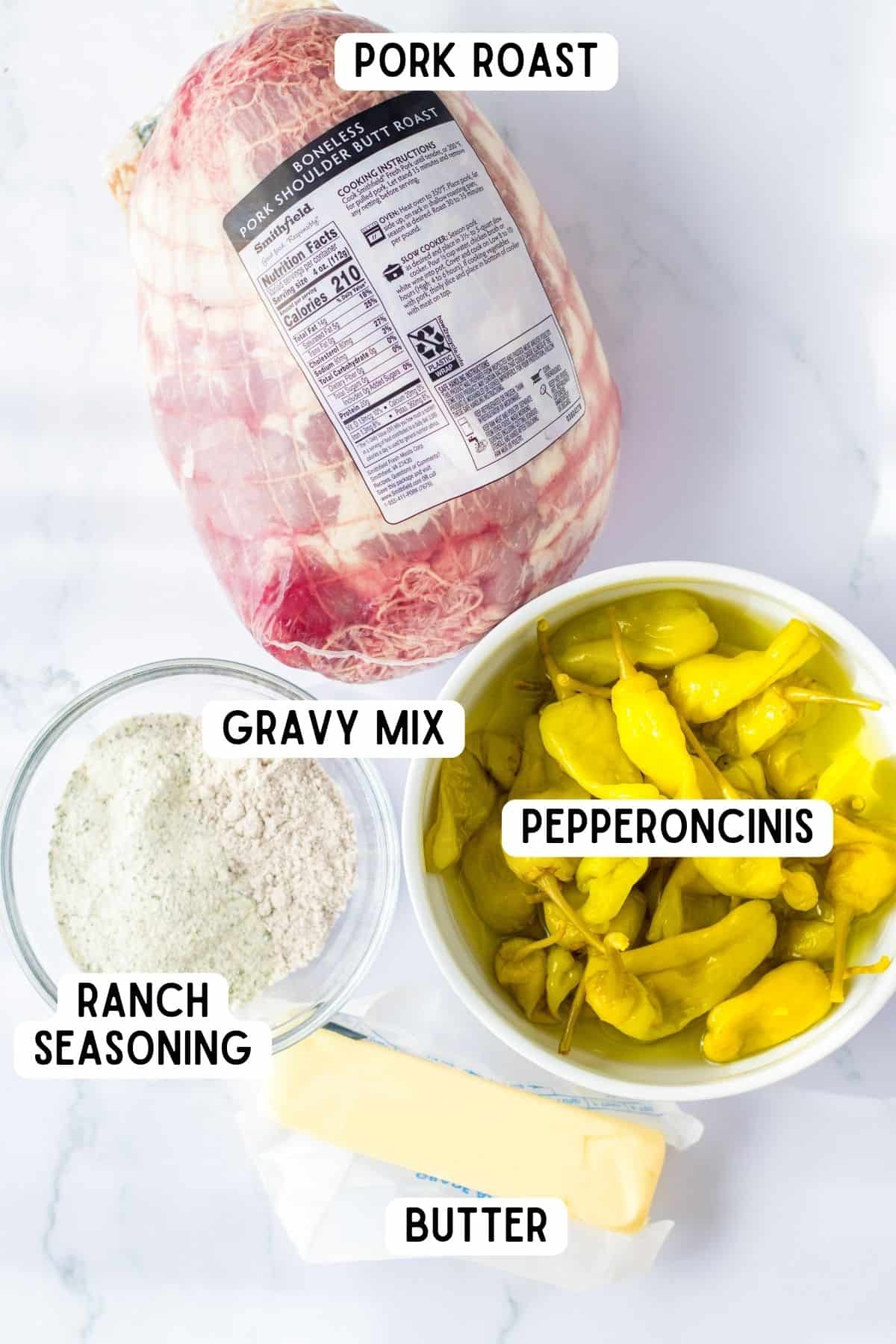 Ingredients for Mississippi Pork Roast: pork shoulder butt, pepperoncini peppers, stick of butter, ranch seasoning, and gravy mix.
