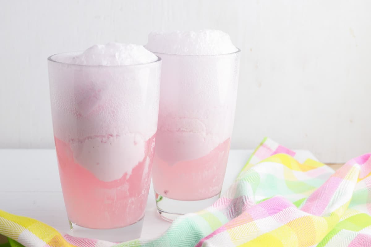 Strawberry punch fizzing up in glasses with the combination of carbonated soda and ice cream.