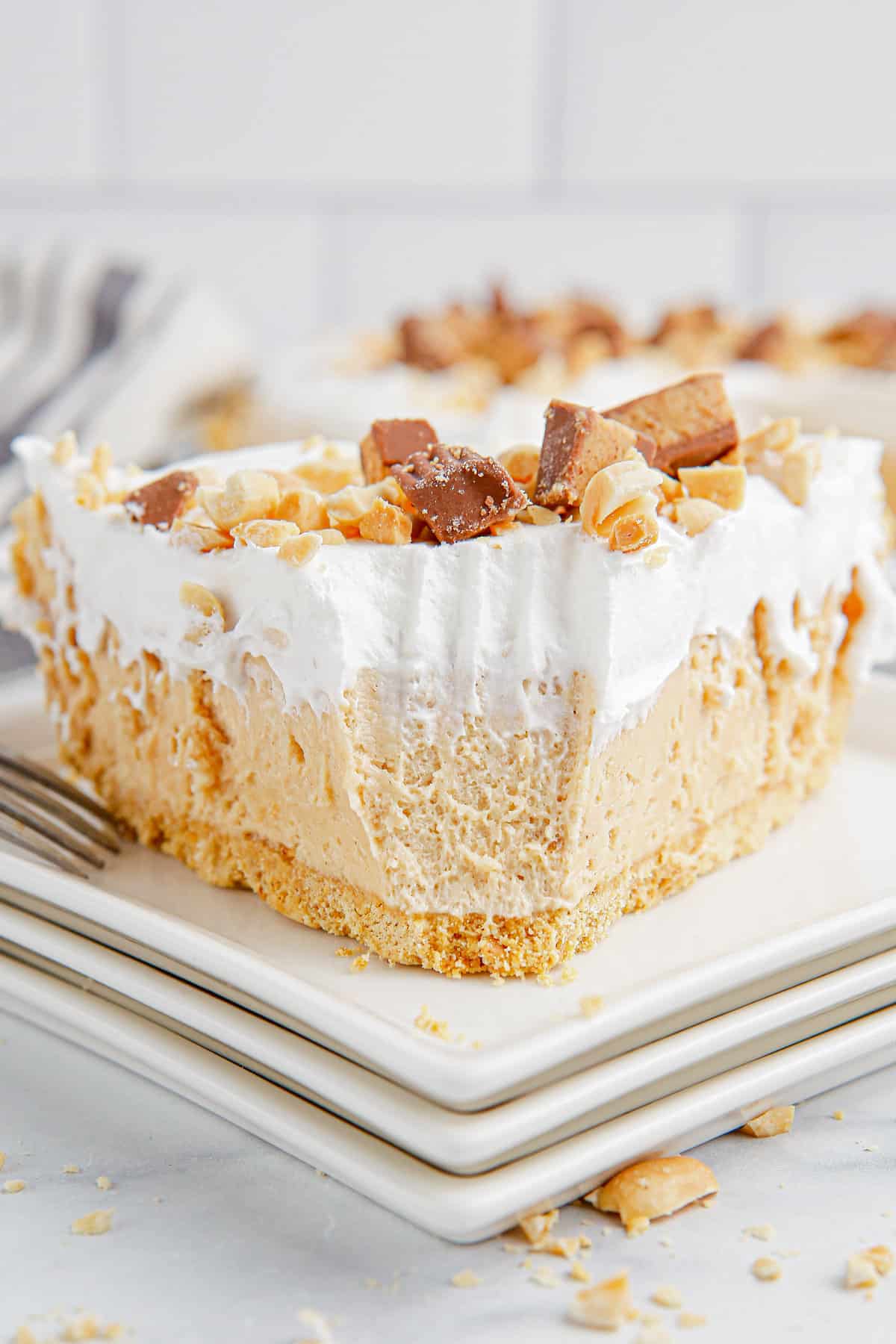 No-bake peanut butter pie with fork marks where one bite has been removed.