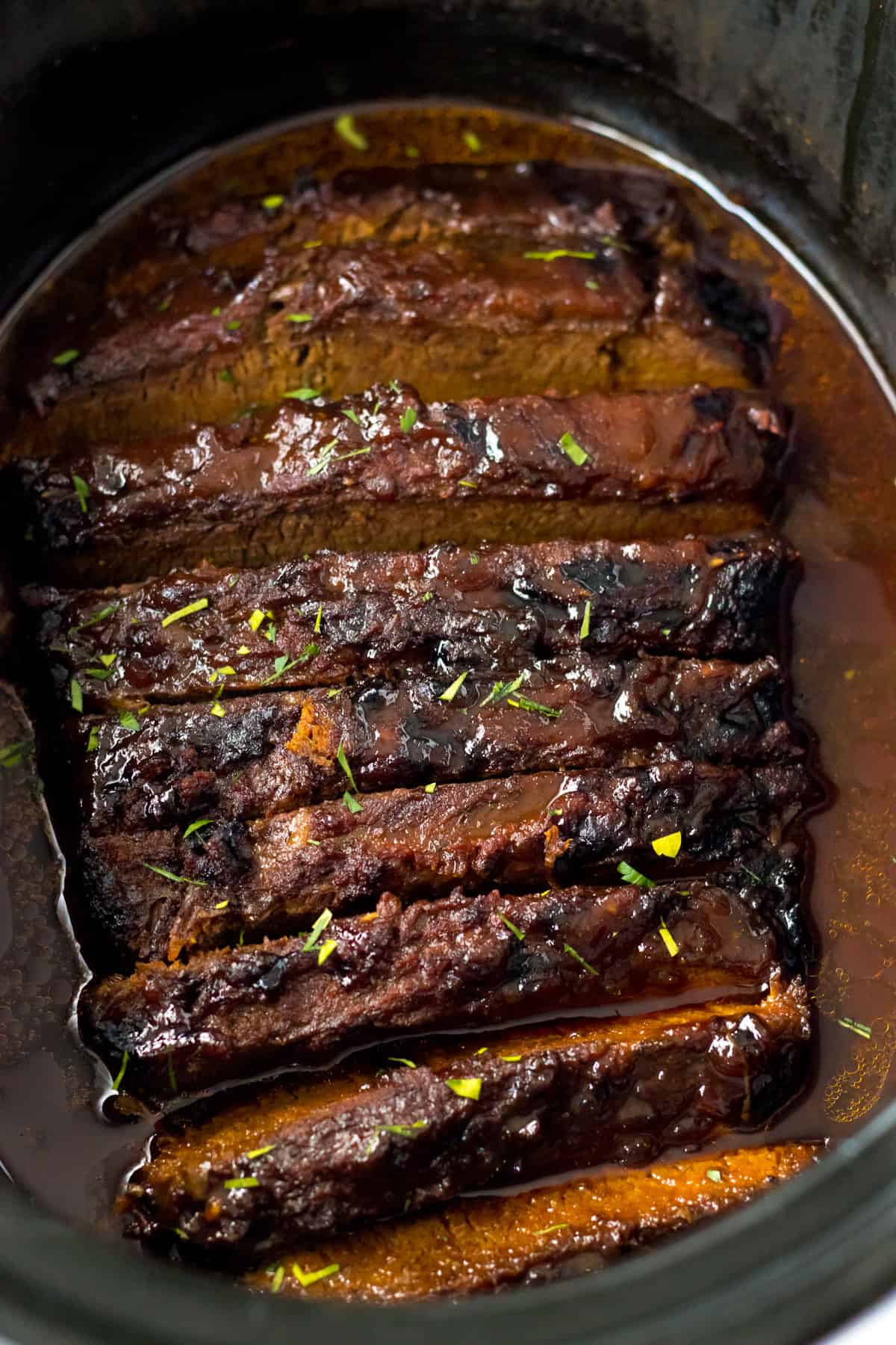Slow cooker brisket with bbq sauce and seasonings.