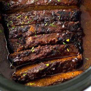 Slow cooker brisket with bbq sauce and seasonings.