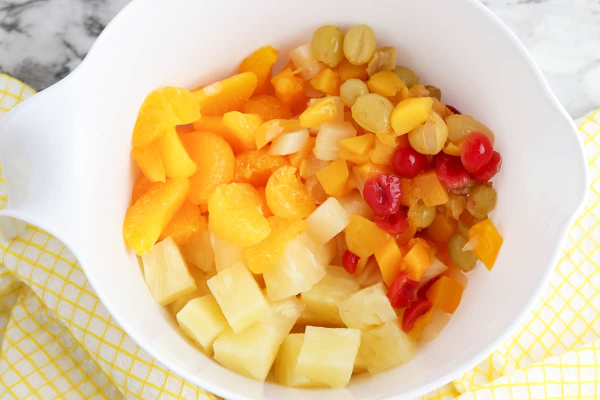 Drained canned fruit in a mixing bowl.