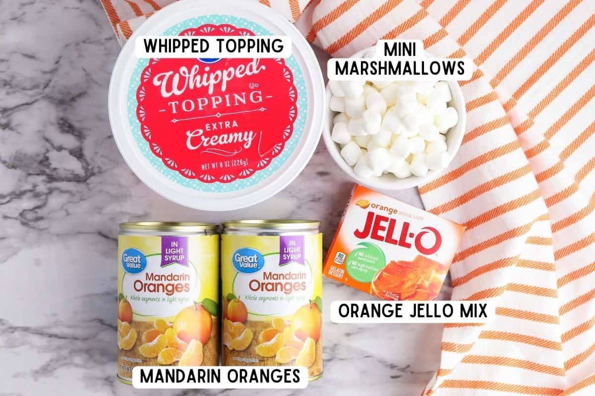Two cans of mandarin oranges, box of orange Jell-o, bowl or mini marshmallows, and container of whipped topping.