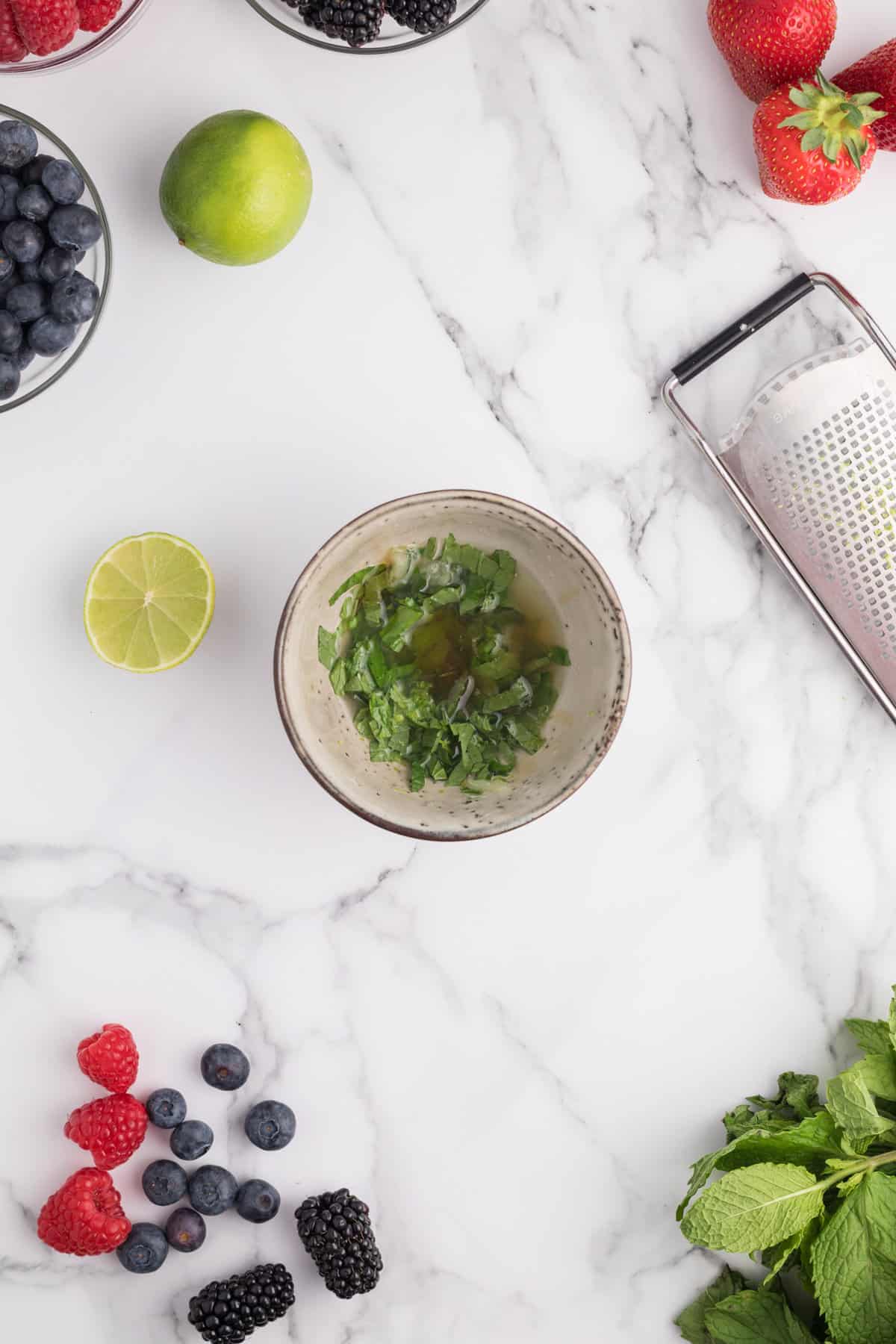 Small bowl with thinly sliced mint, lime juice, lime zest, and honey.