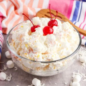 Marshmallow fruit salad with cherries in a large bowl.