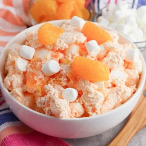 Orange fluff salad with mini marshmallows, mandarin oranges, and jello.