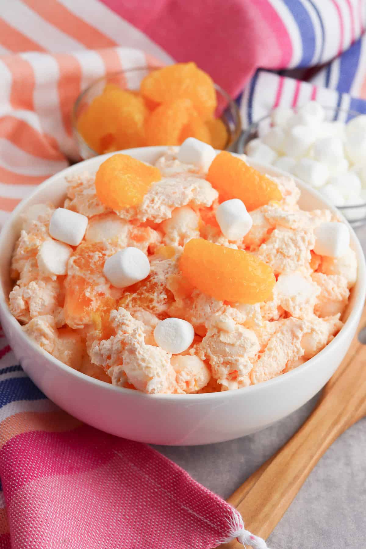 Orange fluff salad with mini marshmallows, mandarin oranges, and jello. 