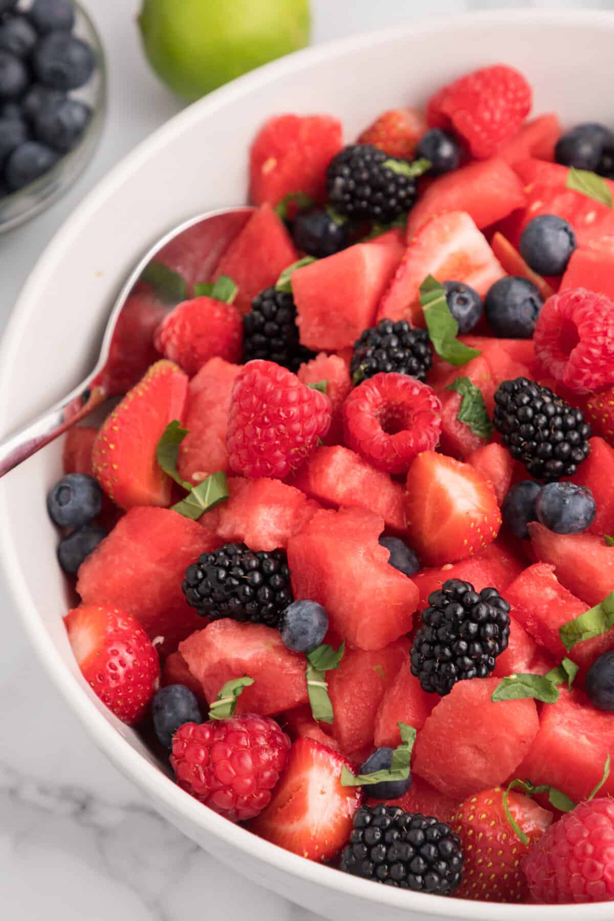 Close up of watermelon fruit salad with mint and fresh berries.