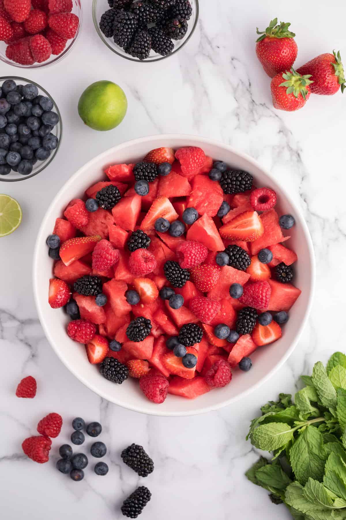 Fresh watermelon and berries in large salad bowl.