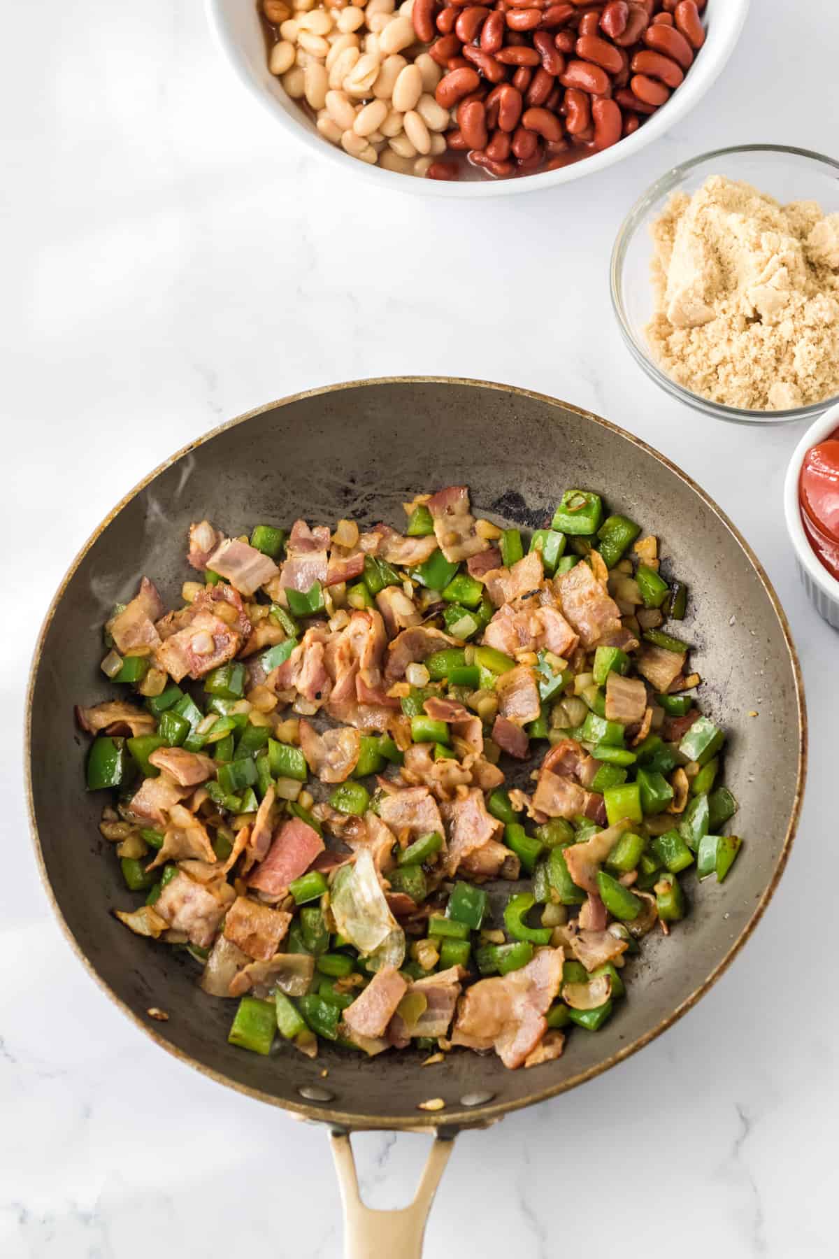 Bacon, green pepper, and onion in large skillet.