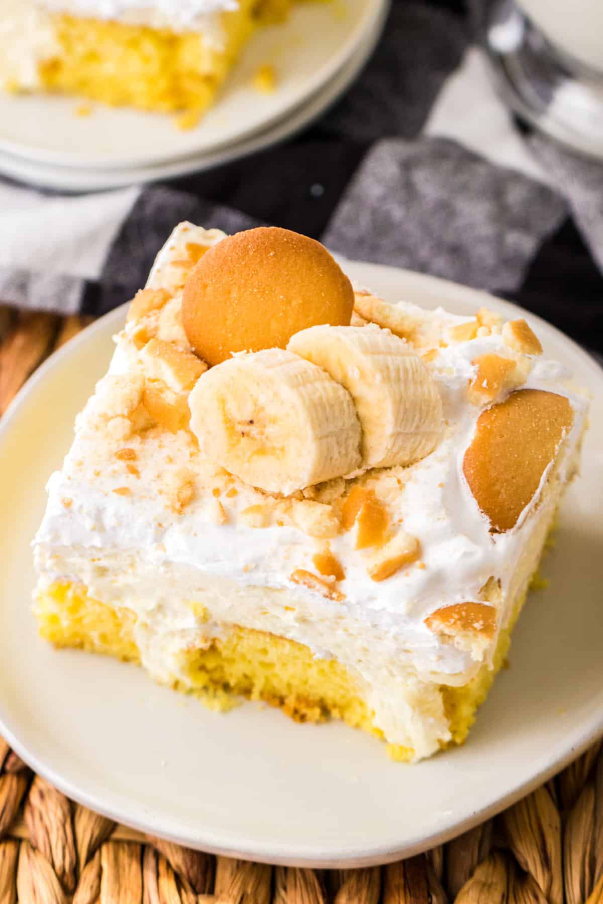 Banana poke cake with banana pudding, nilla wafers, cool whip, and slices of fresh banana.