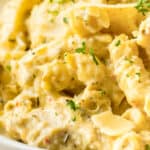 Creamy crockpot garlic parmesan chicken pasta with rotini.