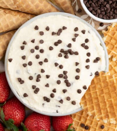 Cannoli dip with waffle cookie dipped into it.