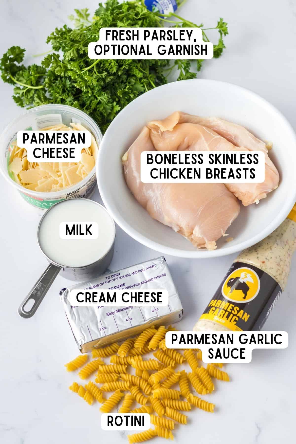 Chicken breasts, Buffalo Wild Wings Garlic Parmesan Sauce, rotini pasta milk, cream cheese, parmesan cheese, and fresh parsley.