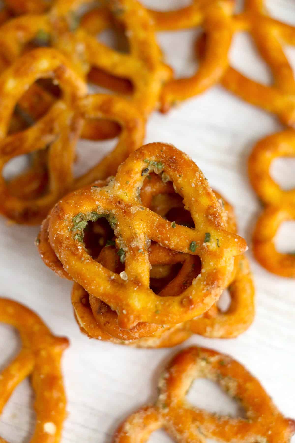 Ranch and garlic seasoned pretzels scatted on table.