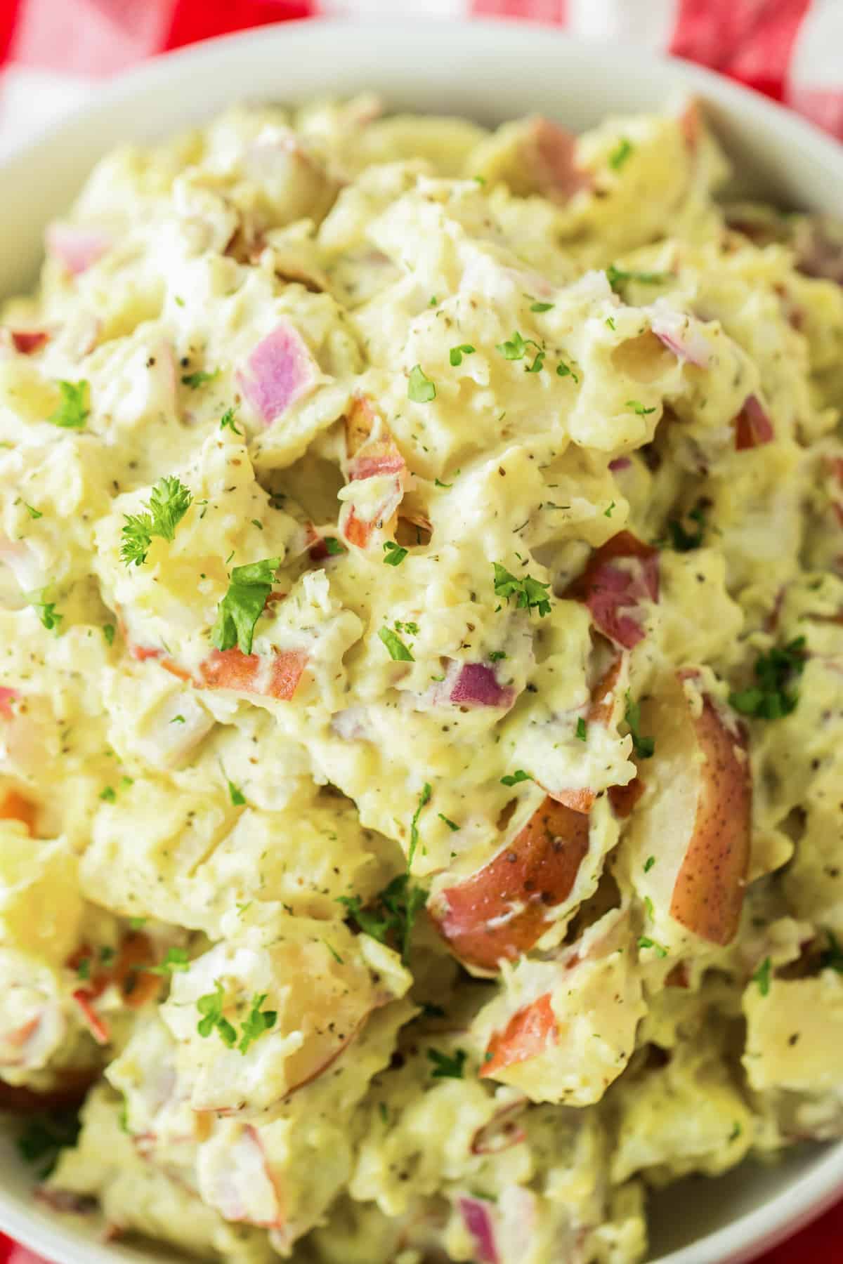 Red skinned potato salad with dill and red onion.