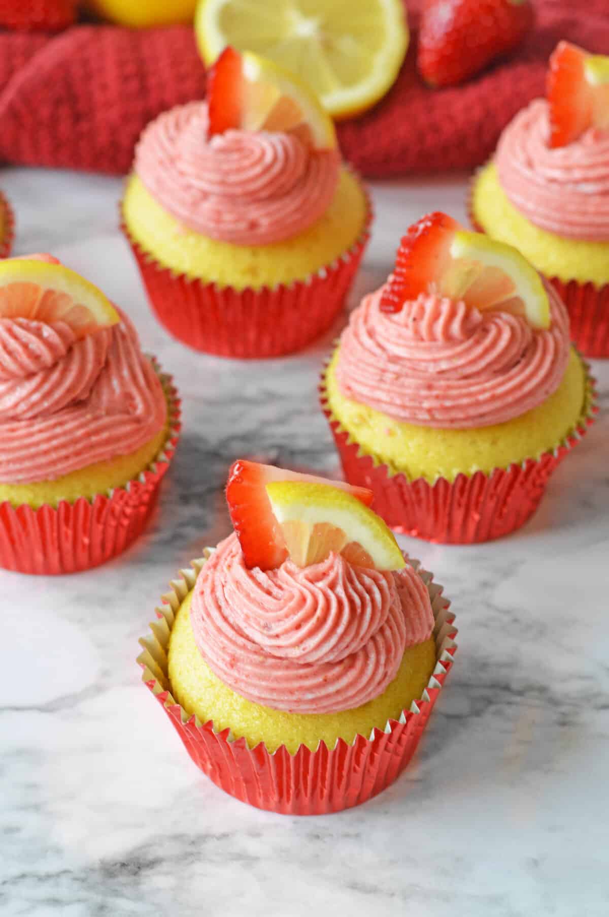 Lemon and Strawberry cupcakes made from lemon cake mix and topped with a strawberry lemonade frosting.
