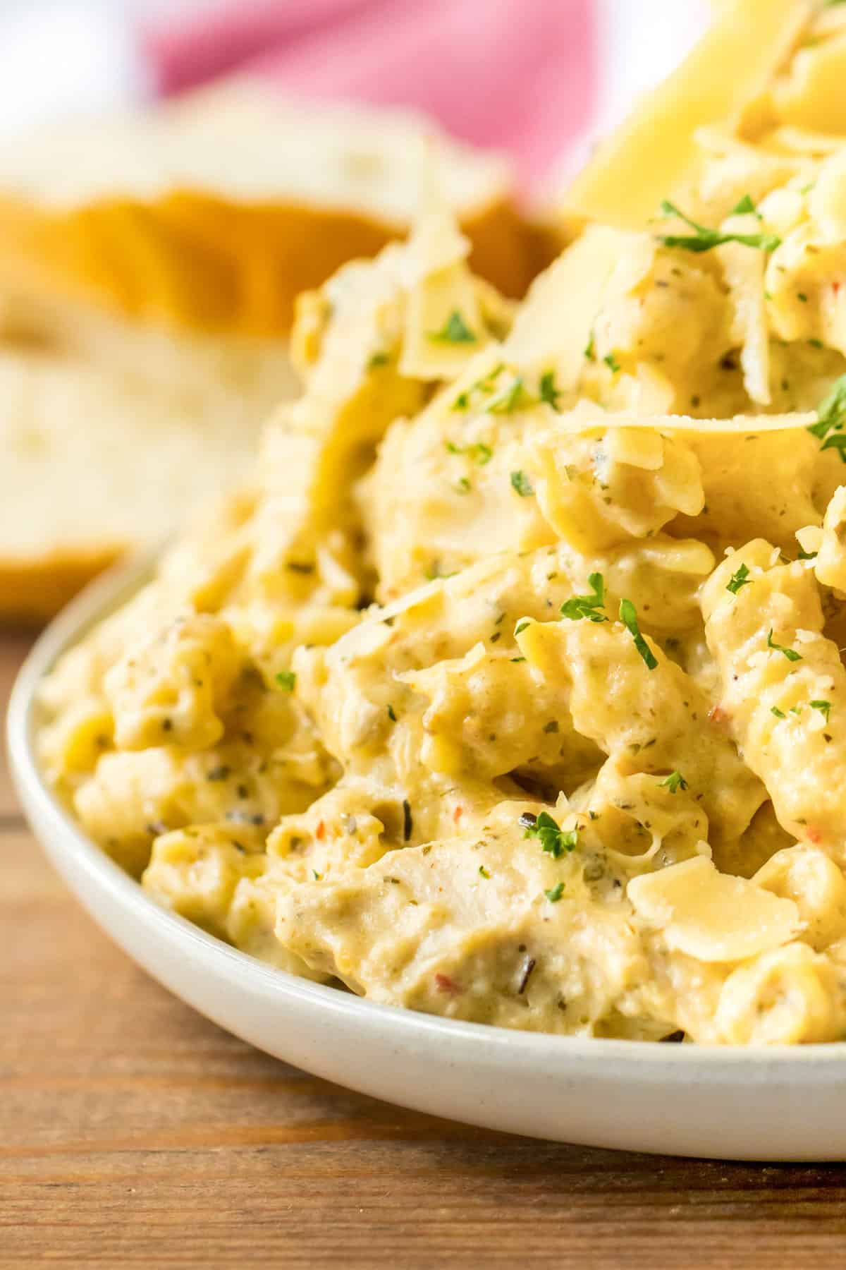 Creamy crockpot buffalo wild wings garlic parmesan chicken pasta served on a white plate.
