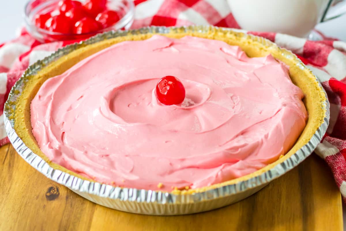 Cherry kool aid pie with cool whip in a graham cracker crust.