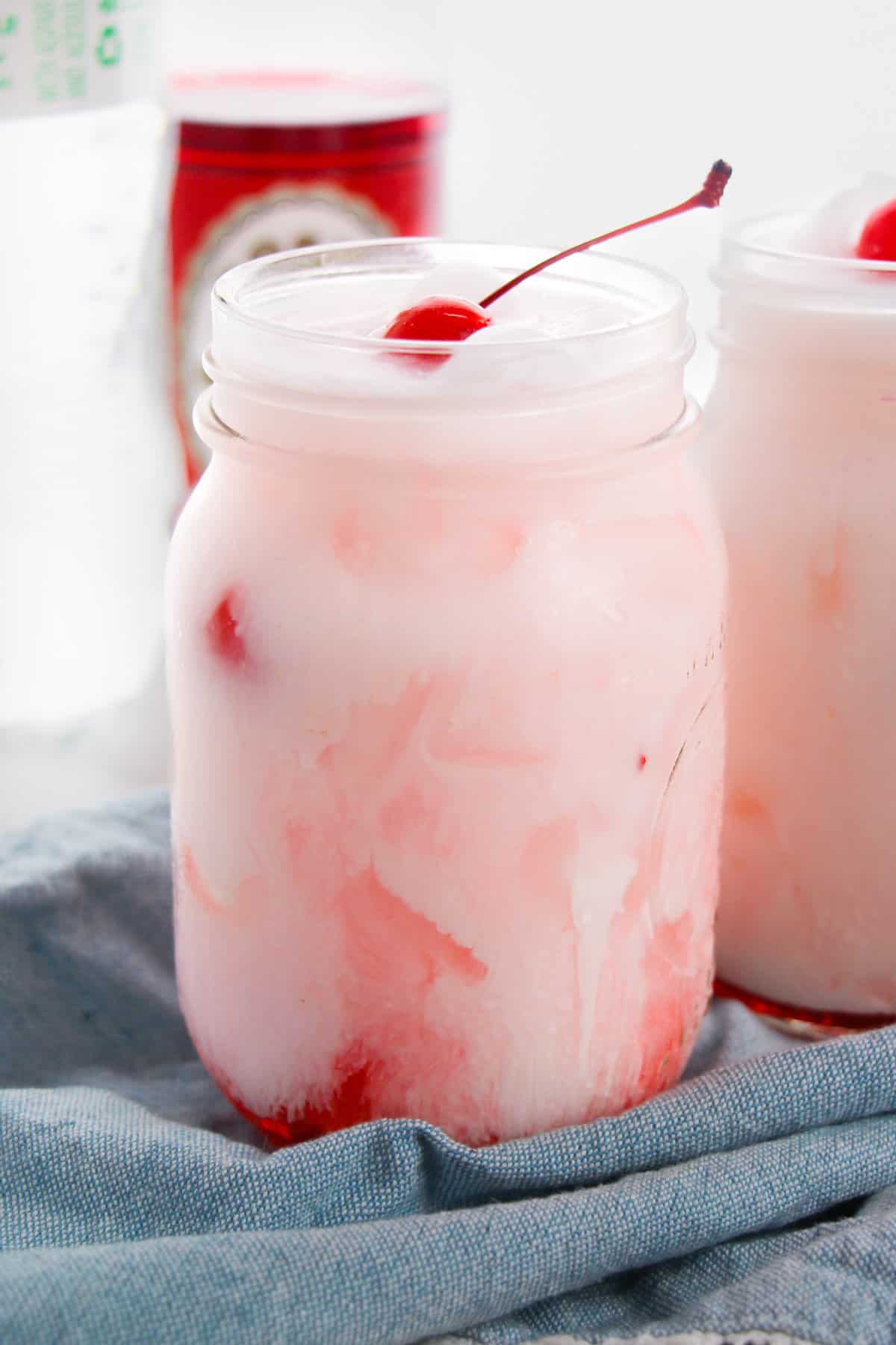 Shirley temple dirty soda with Sprite, grenadine, creamer, and maraschino cherry.