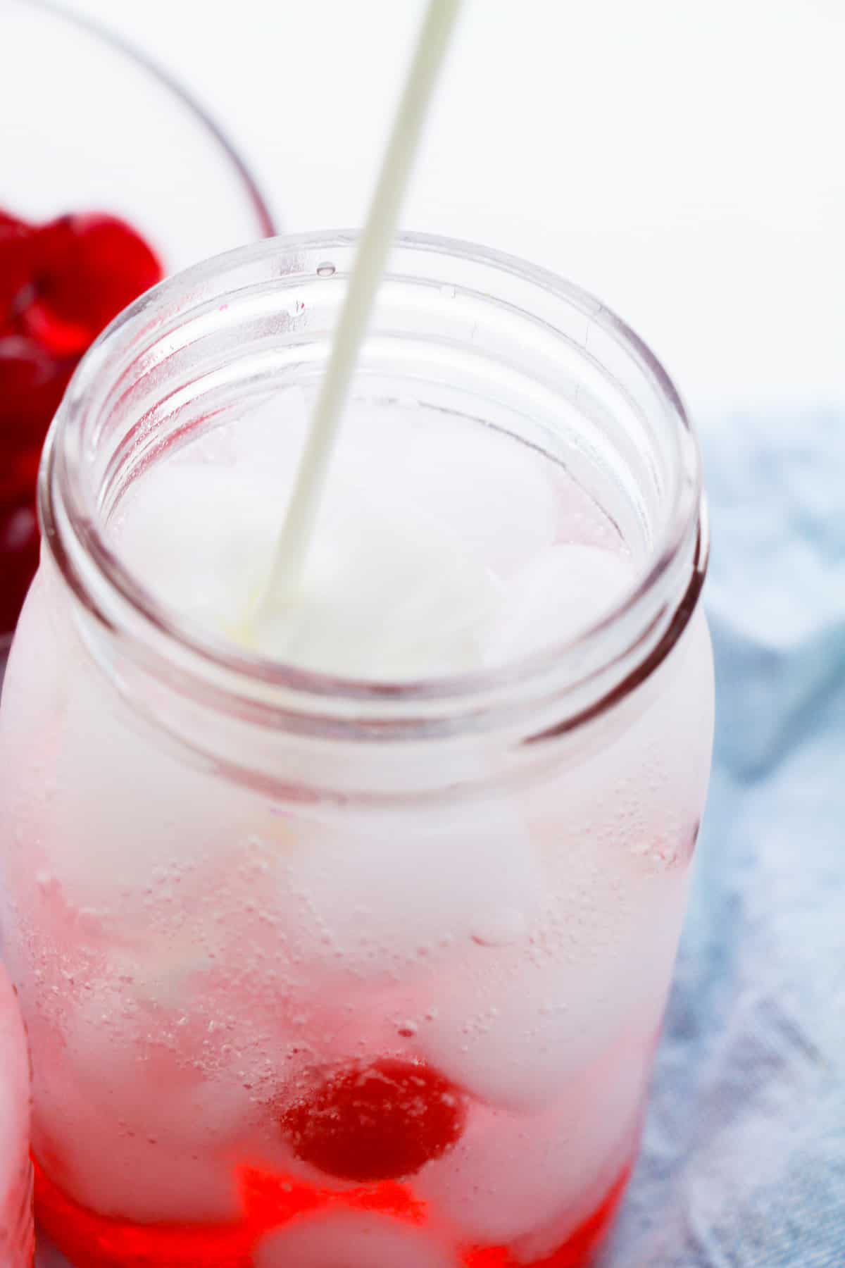 Creamer being poured into mason jar.