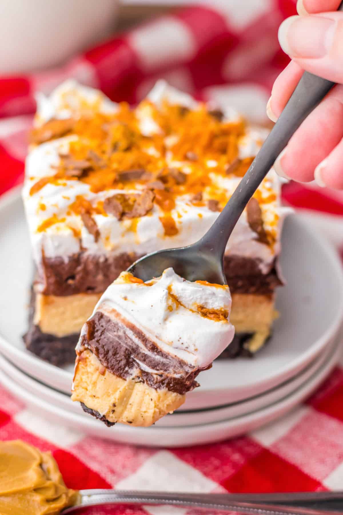 Spoonful of layered butterfinger dessert.