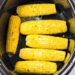 Slow cooker corn on the cob with butter and seasonings.