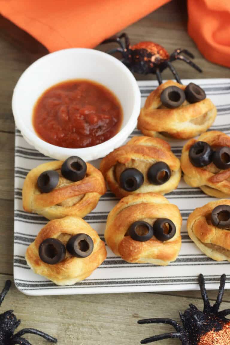 Meatballs baked in dough and topped with olive eyes.