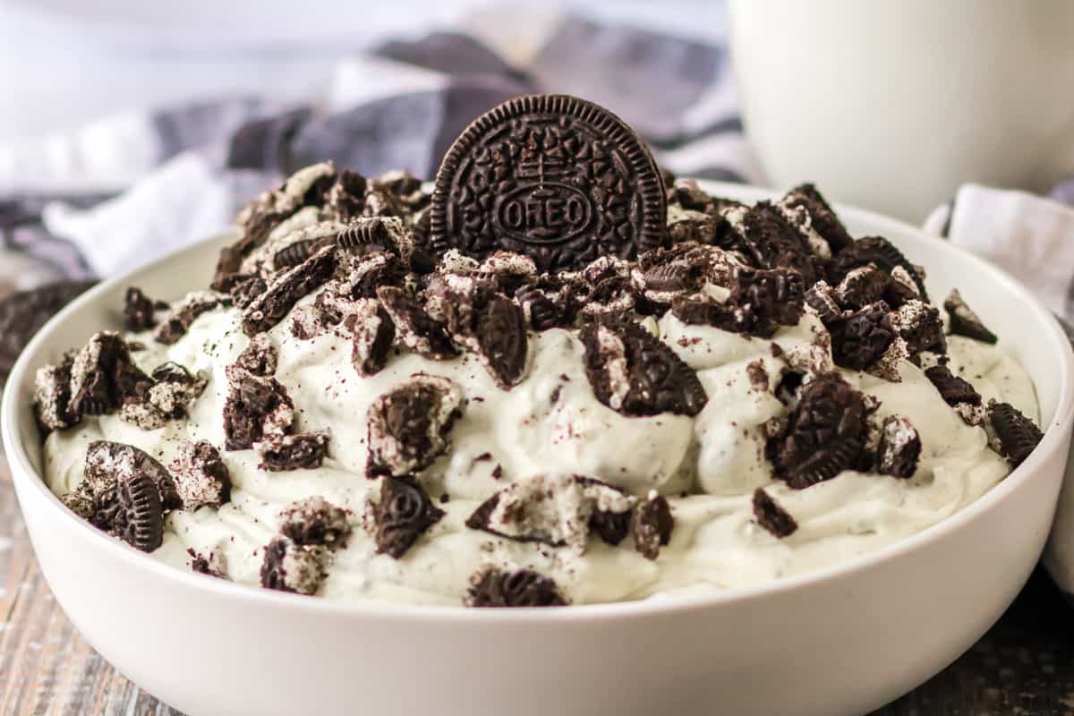 Oreo fluff salad served with a glass of milk.