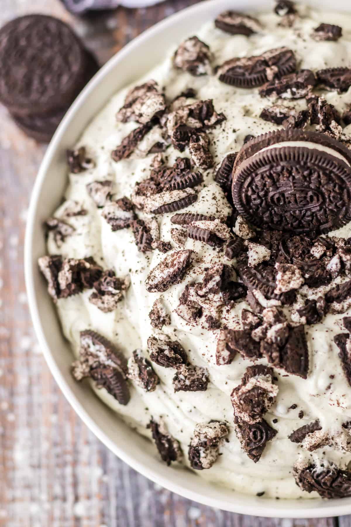 Creamy oreo fluff dessert topped with additional oreo pieces.