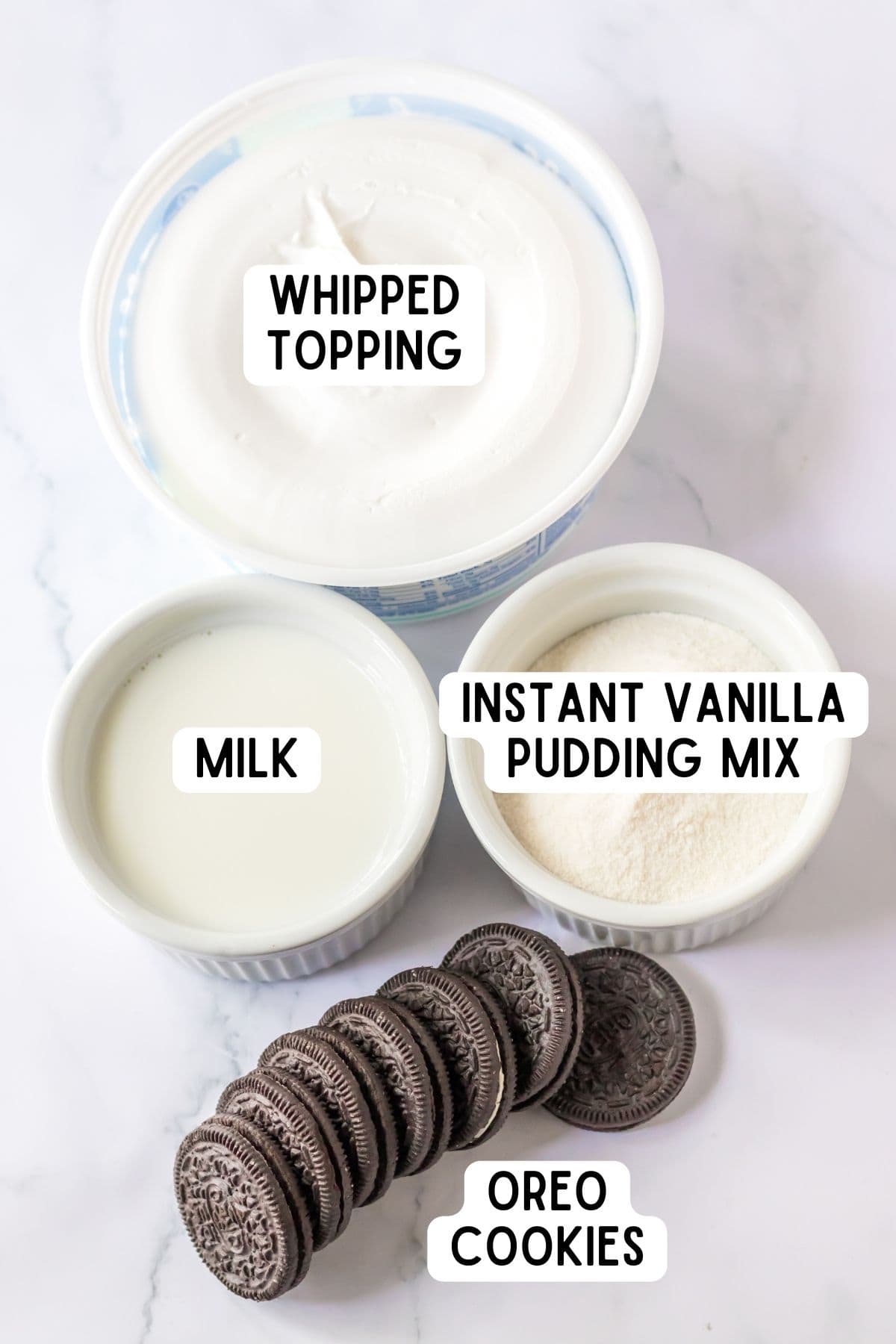 Whipped topping, milk, instant vanilla pudding mix, oreo cookies, and milk.