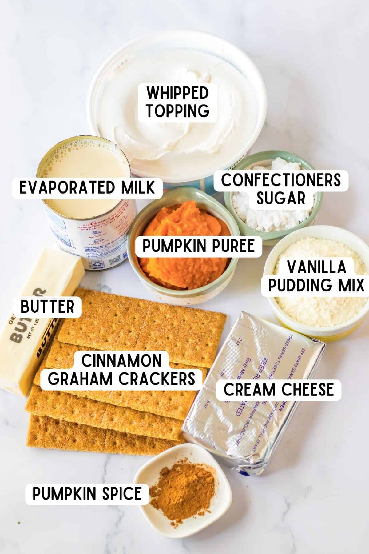 Whipped topping, confectioners sugar, evaporate milk, pumpkin puree, vanilla pudding mix, cream cheese, butter, pumpkin spice, and cinnamon graham crackers.