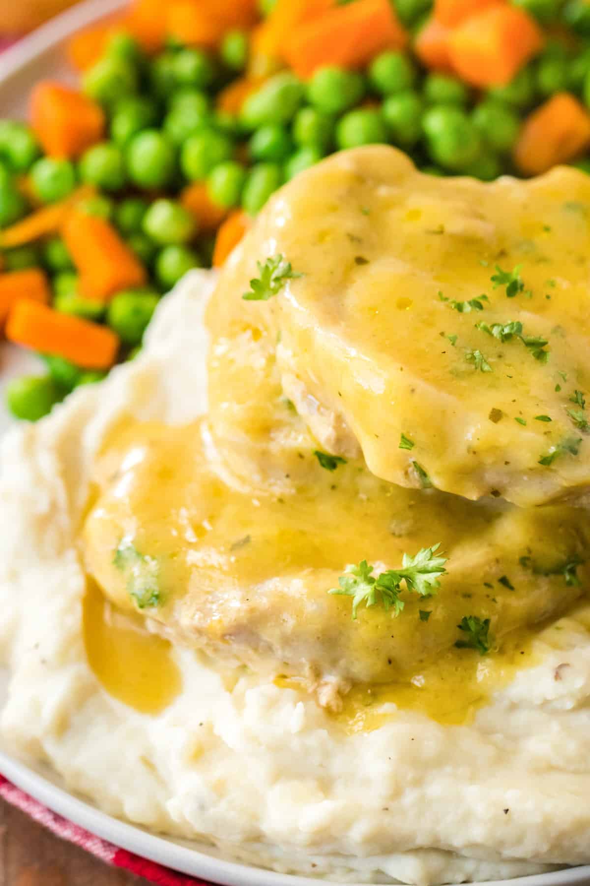 Slow cooker 3 ingredient ranch pork chops served over mashed potatoes.