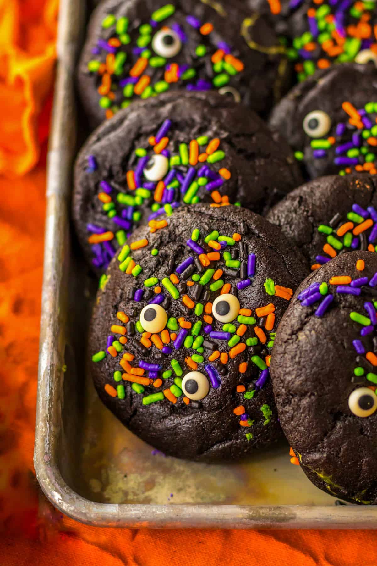 Black Halloween Cookies decorated with sprinkles.