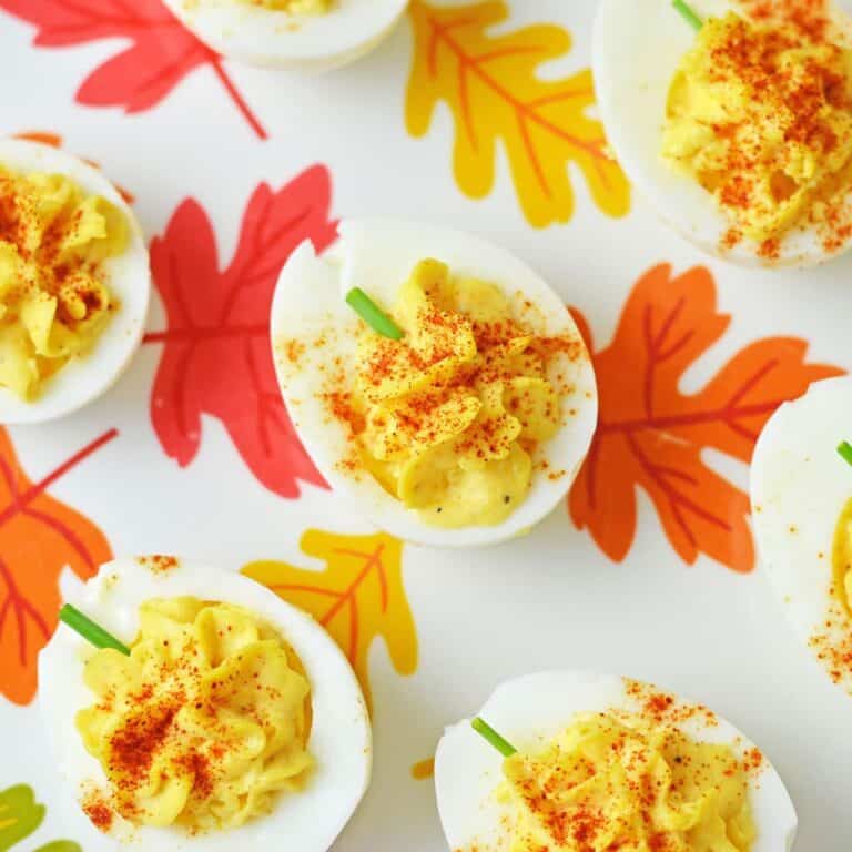 Deviled eggs decorated to look like pumpkins.