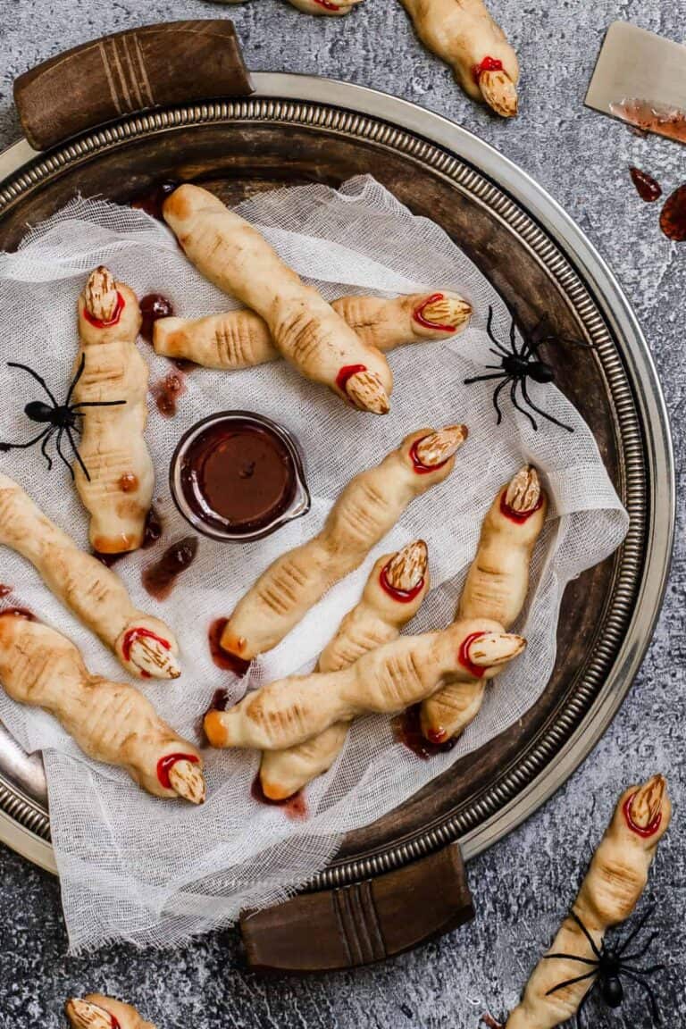 Witch finger cookies with bloody fingernails served with a blood-like dipping sauce.